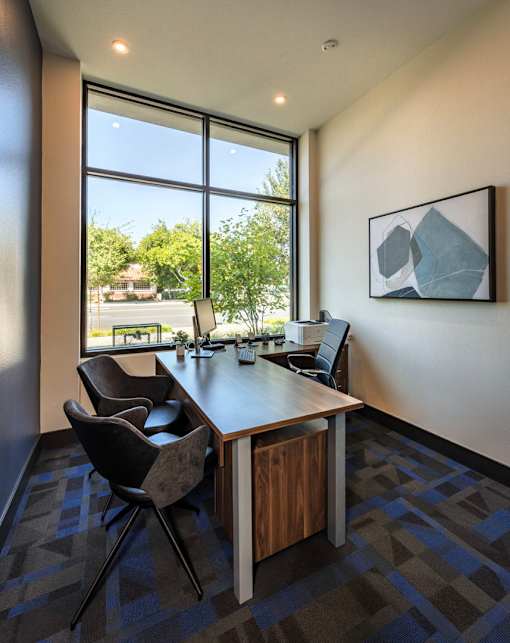 A conference room with a long table and chairs.