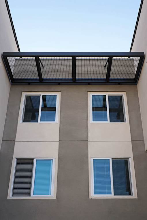 A building with a flat roof and three windows.