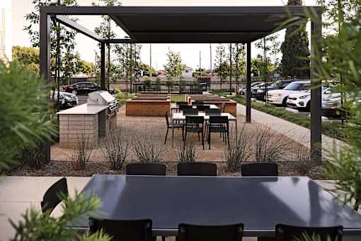 A patio with a table and chairs under a roof.