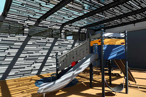 A slide in a playground with a blue cover and a yellow slide.