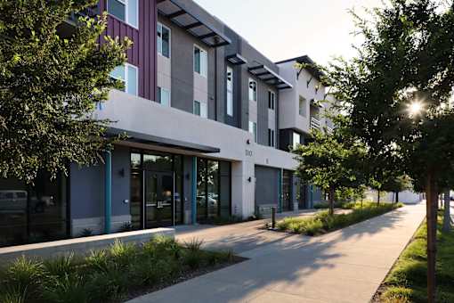 A modern building with a walkway in front of it.