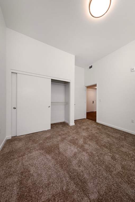 A room with carpeted floor and white walls.