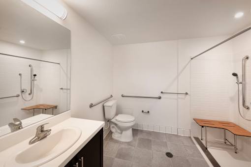 A bathroom with a toilet, sink, and shower.