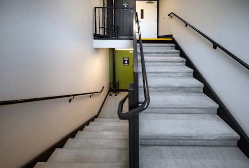 A staircase with a yellow box on the side.