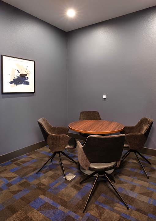A conference room with a brown table and chairs.