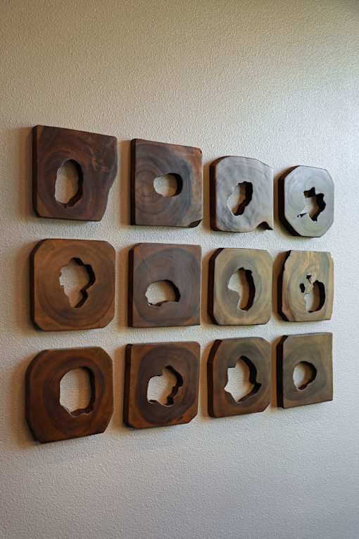 A wall with a series of wooden blocks with cutouts.