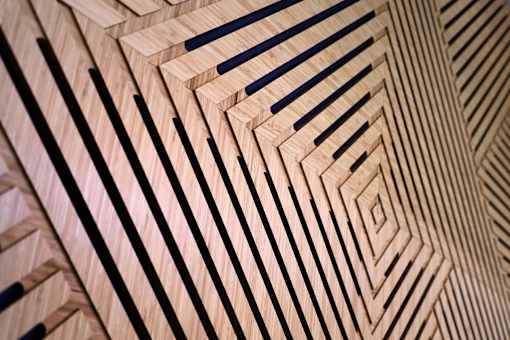 A wooden surface with black lines creating a geometric pattern.