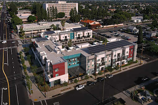 A street view of a residential area with apartment buildings.