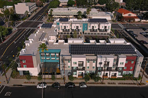 A street view of a residential area with apartment buildings.