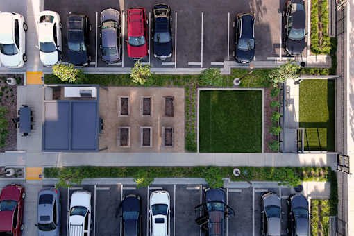 A parking lot with cars parked in rows.