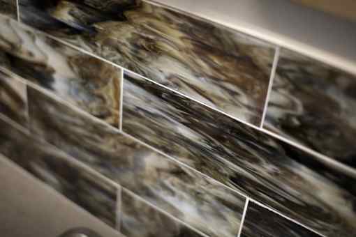 A close up of a marble tile wall.
