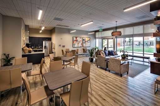 A large room with tables and chairs and a view of the outside.