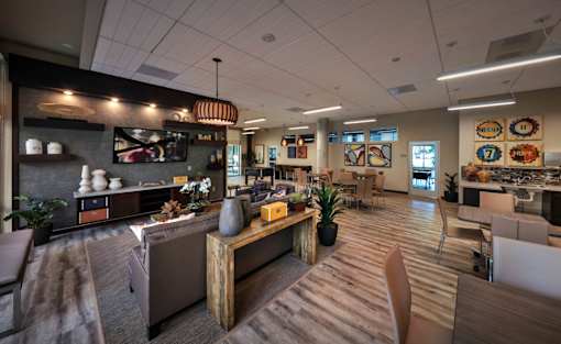 A modern kitchen with a wooden island and bar stools.