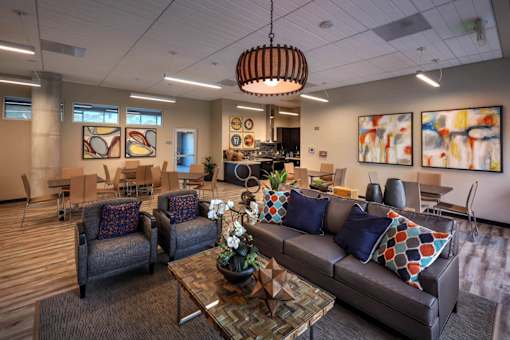 A modern living room with a grey couch and a wooden coffee table.