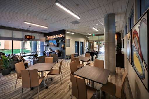 A modern dining room with wooden tables and chairs.