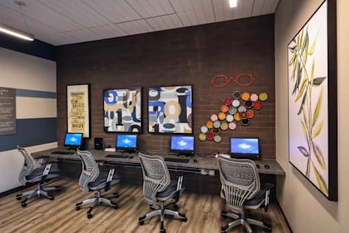 A room with a long desk and chairs with a sign that says "Give Your Mind Body".