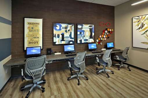 A room with a brown wall and a poster that says "Reading is to the mind what exercise is to the body".