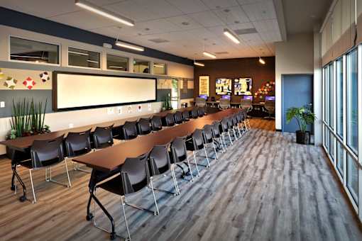 A conference room with a long table and chairs.