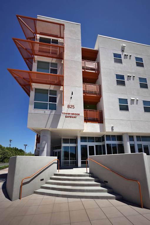 A white and orange building with the words "Tower Bridge Gateway" on the front.