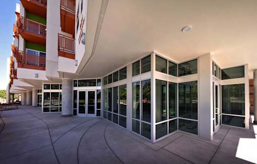 A modern building with a glass facade and a white roof.