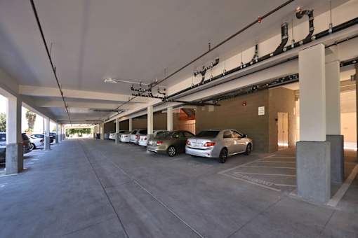 A parking garage with cars parked in it.