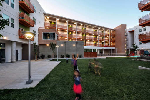 A building with a green lawn in front of it.