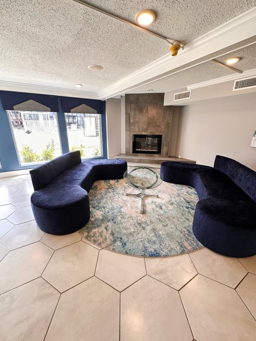 a living room with blue couches and a fireplace