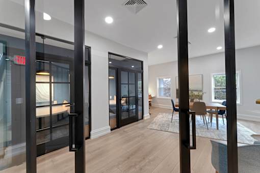 A modern interior with a glass door and a wooden floor.