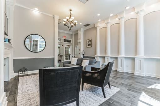 a living room with white pillars and a table and chairs  at Cumberland Crossing, Cumberland, 02864