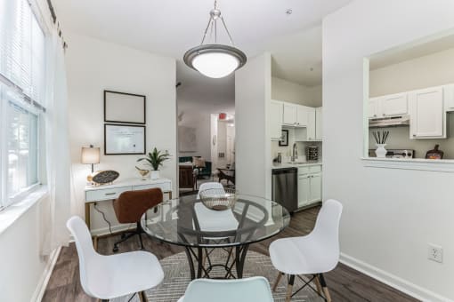 an open living room and dining room with a glass table and chairs  at Cumberland Crossing, Cumberland, Rhode Island