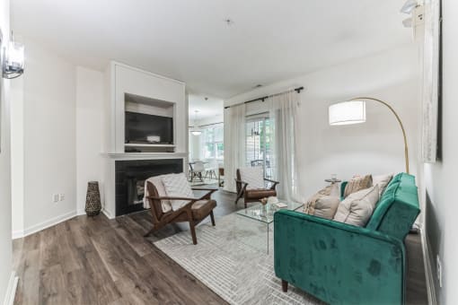 living room with a green couch and a fireplace at Cumberland Crossing, Cumberland, 02864