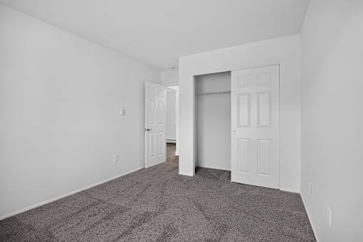 A room with a carpeted floor and white walls.