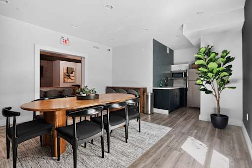 A modern dining room with a wooden table and chairs.