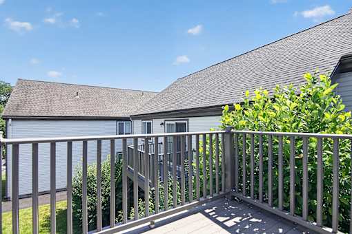 A house with a grey roof and a grey deck.