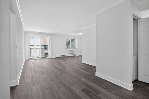 A room with wooden floors and white walls.