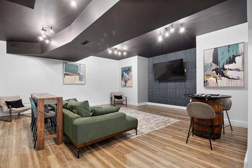 A living room with a green couch and a wooden table.