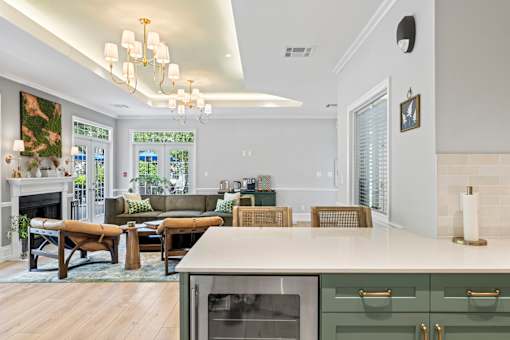 A modern kitchen with a stainless steel oven and a dining table with chairs.