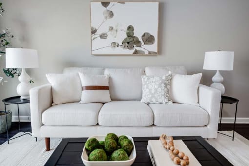 a living room with a white couch and a table at Pleasant View Estates, Griswold
