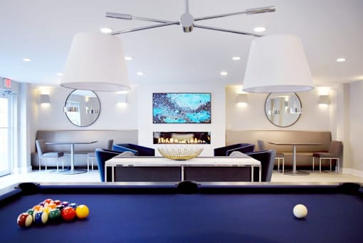 A pool table with a white ball on it.
