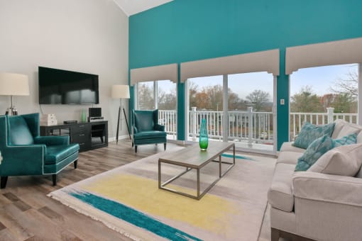 A living room with a glass coffee table and a white couch. at South Winds Apartments, Fall River, 02720