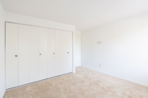A room with a white wall and a carpeted floor. at South Winds Apartments, Fall River, 02720