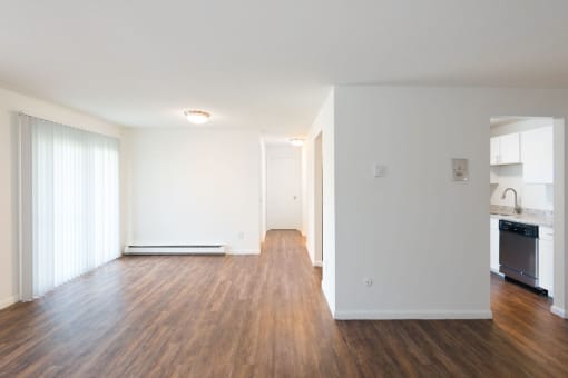 A spacious room with wooden floors and white walls. at South Winds Apartments, Fall River, MA, 02720