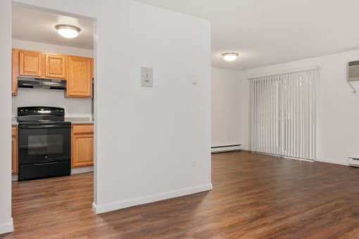 A kitchen with wooden cabinets and a black oven. at South Winds Apartments, Massachusetts