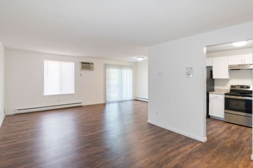 A large empty room with wooden floors and white walls. at South Winds Apartments, Fall River, MA