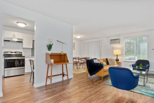 A modern living room with a wooden floor and furniture at South Winds Apartments, Fall River, 02720.