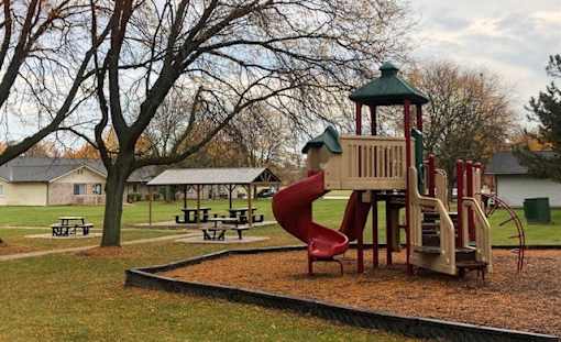 a playground with a slide in a park