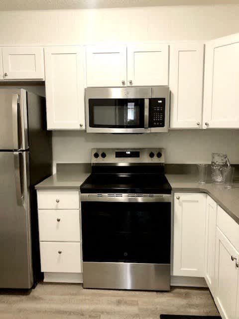 a kitchen with a stove and a microwave