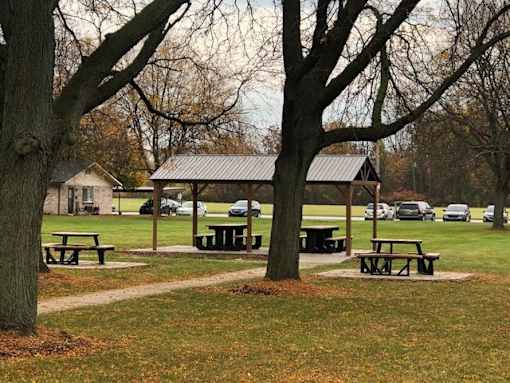 a park with picnic tables and a pavilion