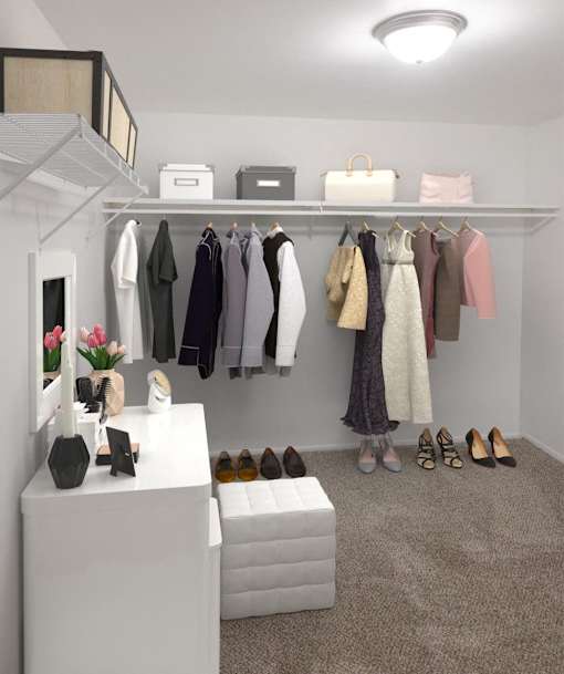 a walk in closet filled with clothes and shoes