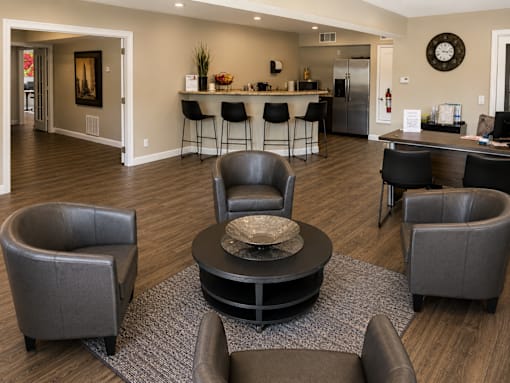 A living room with a grey sofa and a black coffee table.